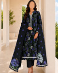 Woman wearing a floral dress with a matching long coat in an outdoor setting