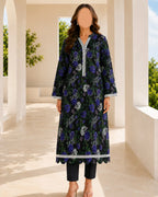 Woman wearing a dark floral dress with white accents in an outdoor setting.