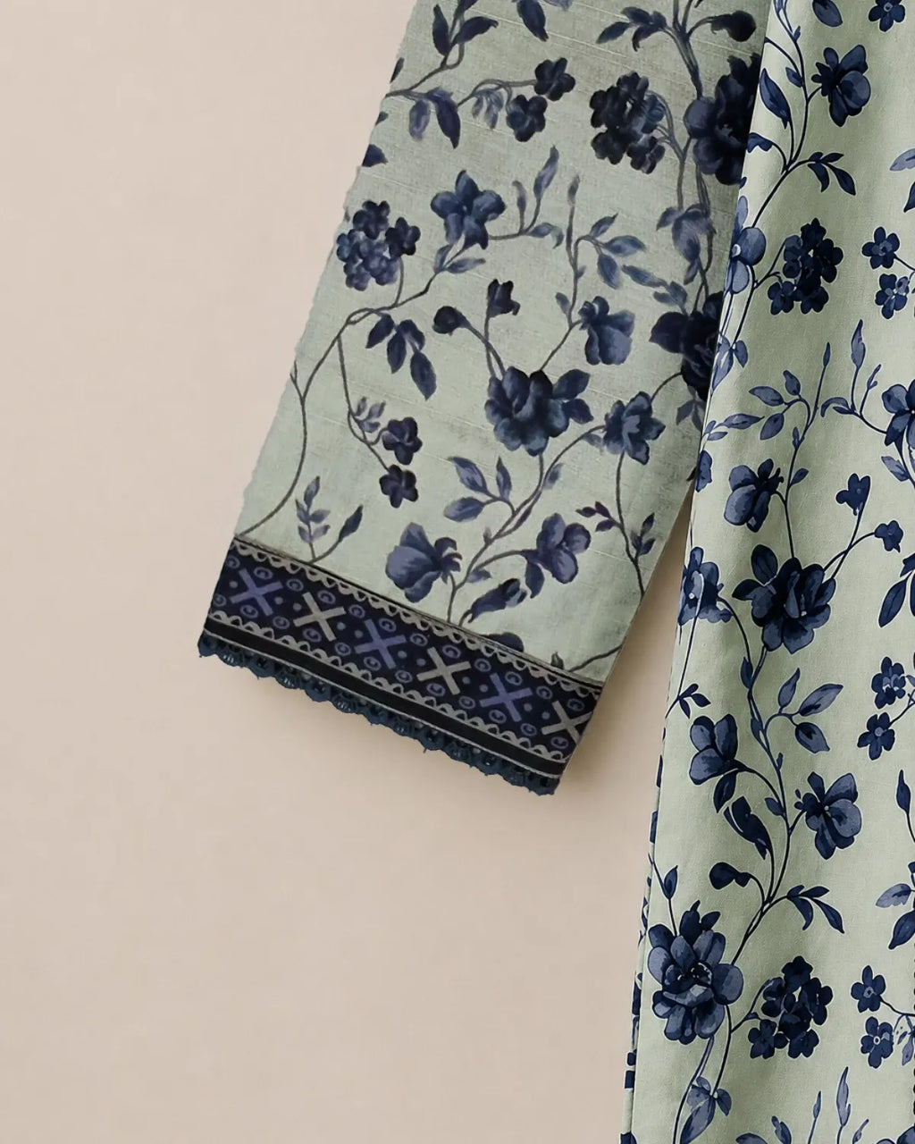 Floral patterned fabric with blue flowers on a light green background