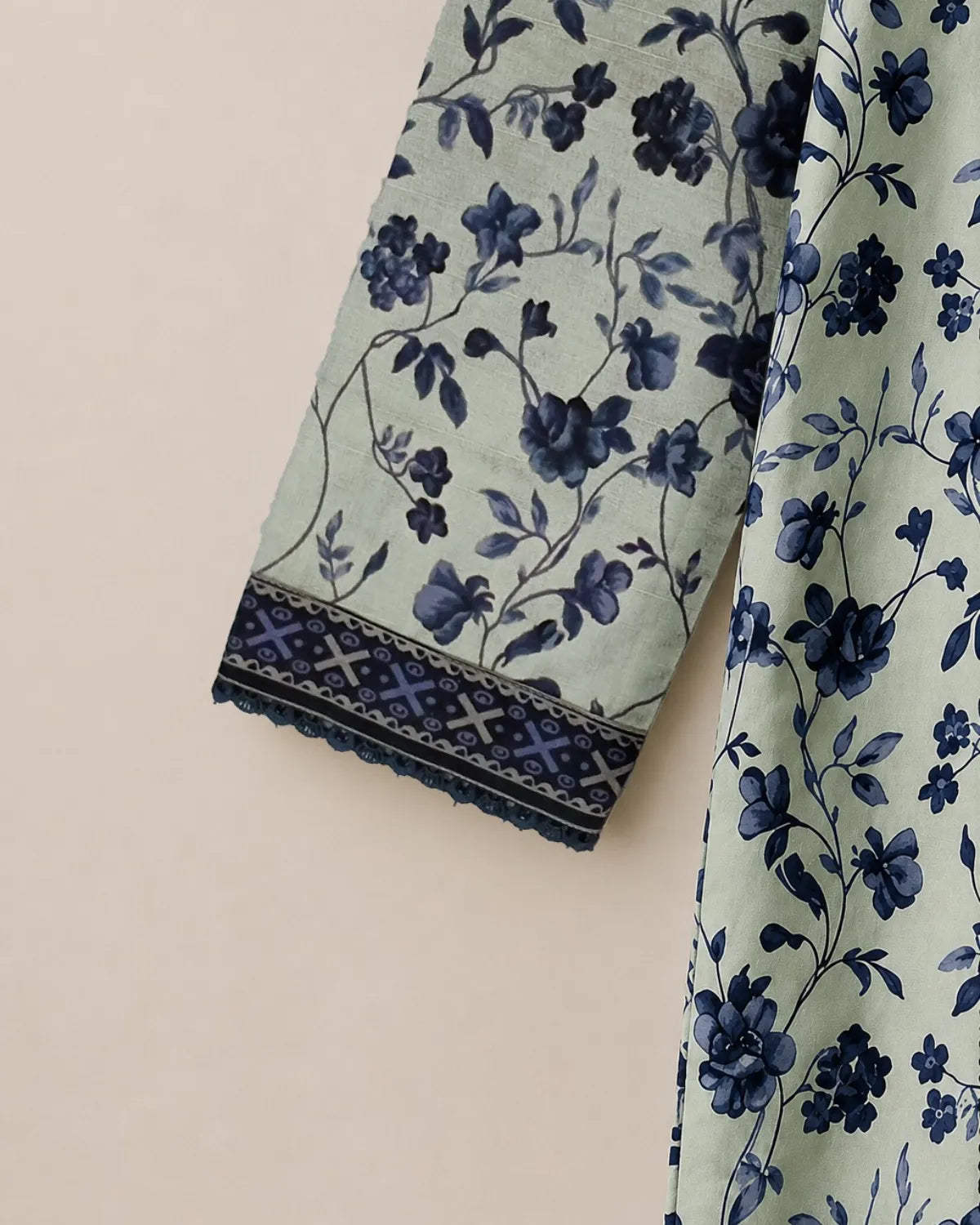 Floral patterned fabric with blue flowers on a light green background