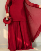 Flowy deep red sharara trousers paired with a matching shirt.