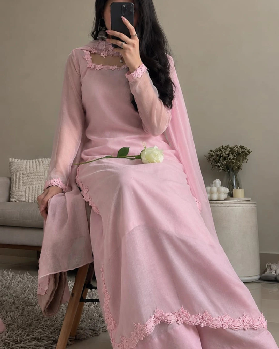 Pastel pink shirt featuring delicate floral lace on the neckline and sleeves.