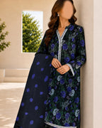 Woman wearing a dark floral dress with a matching shawl indoors.