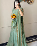 Timeless QAM Style festive fashion featuring a sage green embroidered ensemble, luxurious-looking fabric, intricate golden accents, and a beautifully draped chiffon dupatta.