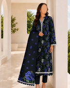 Woman wearing a black floral dress with blue flowers in an outdoor setting
