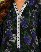 Floral patterned garment with white lace trim on a black background