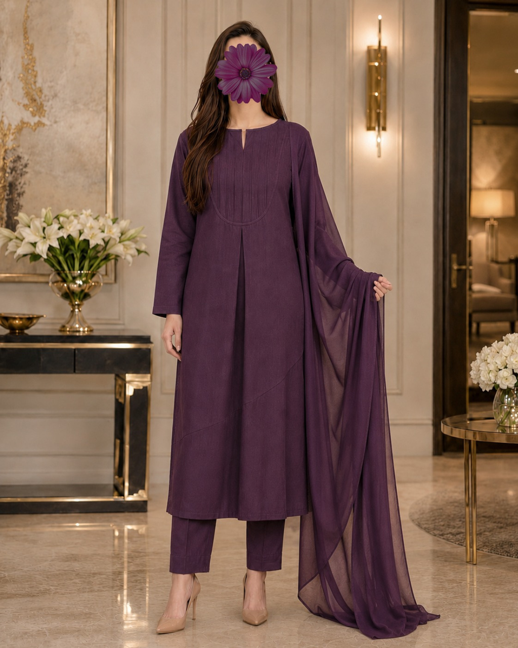 A woman models a three-piece traditional outfit in deep purple, featuring a long kurta, matching trousers, and a sheer dupatta, set against an elegant indoor background.