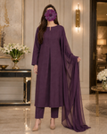 A woman models a three-piece traditional outfit in deep purple, featuring a long kurta, matching trousers, and a sheer dupatta, set against an elegant indoor background.