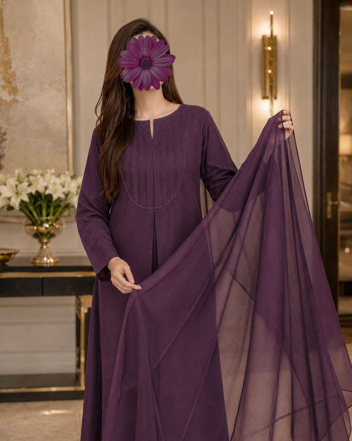 A woman wearing a long-sleeved purple kurta with a matching sheer dupatta, standing in an elegant indoor setting. A large purple flower is digitally placed over her face.
