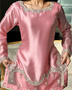 A pink long-sleeve kurta dress with intricate silver and white embroidery around the neckline, cuffs, and hem, shown on a model.