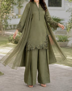 Woman wearing an olive green traditional outfit with a matching dupatta in an outdoor setting.